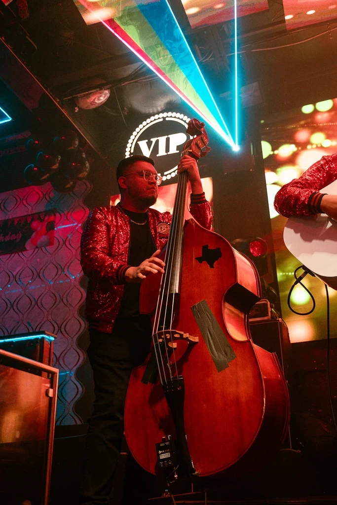 Bryan playing upright bass on stage